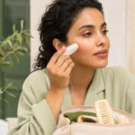 Femme appliquant une protection solaire en stick sur un maquillage léger